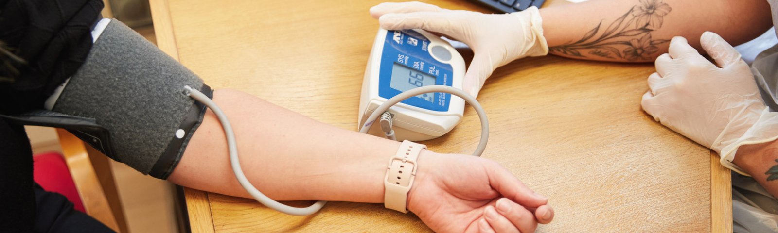 A photo showing a nurse taking a patients blood pressure